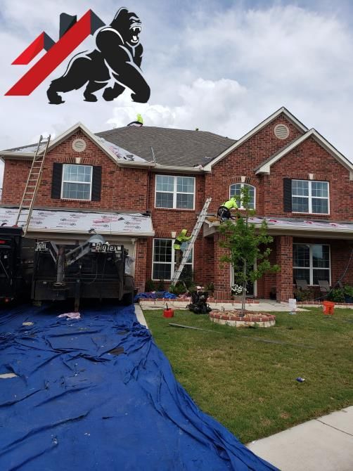 A group of workers installing siding on a house.