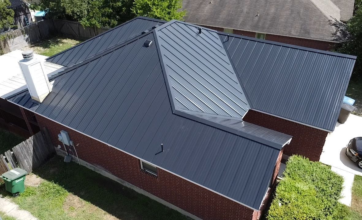 A group of workers installing siding on a house.