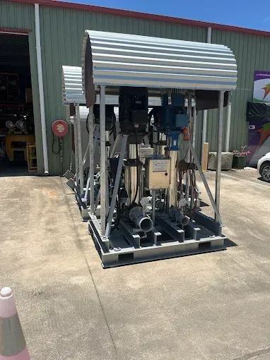 Two Industrial Pumps Inside a Metal Frame, Parked Outside a Building — Keyeng in Slade Point, QLD