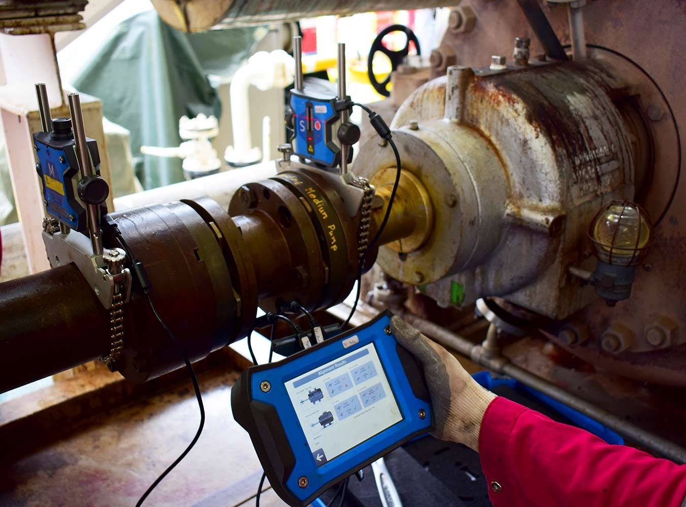 A Technician Using a Blue Diagnostic Device on a Large, Rusty Industrial Machine — Keyeng in Slade Point, QLD