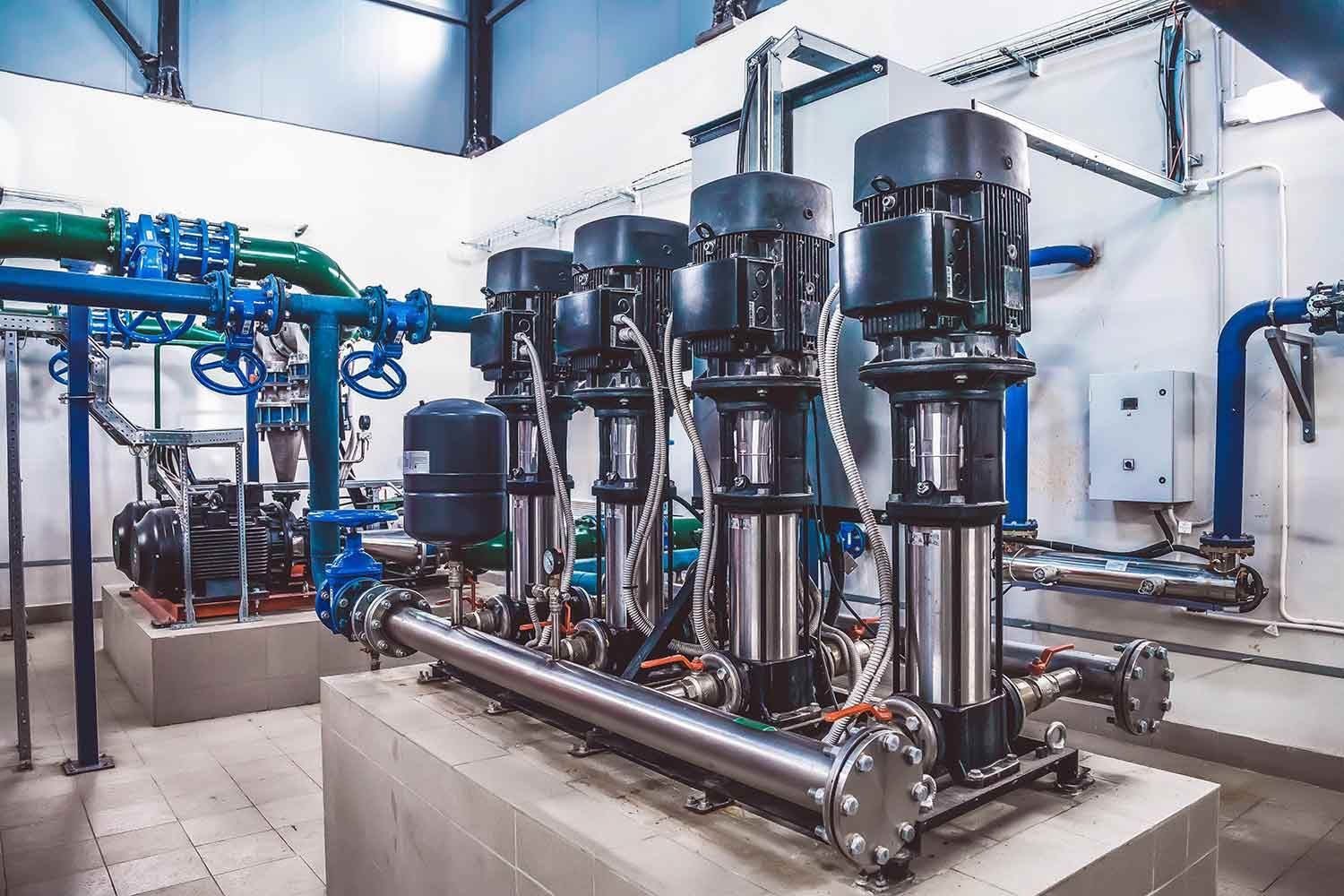 Water Pump System With Several Vertical Pumps and Blue and Green Piping — Keyeng in Slade Point, QLD