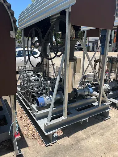 Silver Industrial Pump System on a Steel Frame With a Corrugated Metal Roof Outdoors — Keyeng in Slade Point, QLD