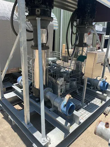 Water Pump System on a Metal Frame, With Two Electric Motors, Piping, and Blue Couplings — Keyeng in Slade Point, QLD