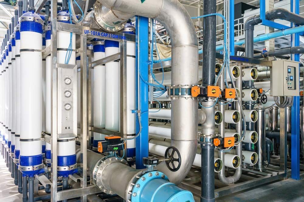 Industrial Water Treatment System With White Filtration Cylinders, Blue Pipes, and Metal Valves — Keyeng in Slade Point, QLD