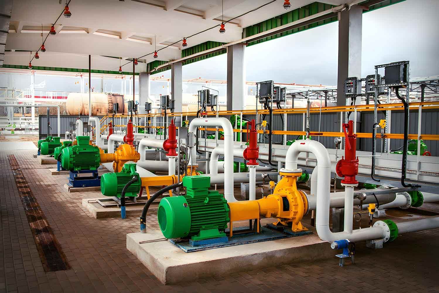 Pumps at an Industrial Facility. Green and Yellow Pumps With White Pipes and Red Valves — Keyeng in Slade Point, QLD