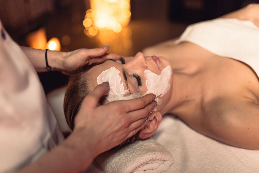A woman is getting a facial treatment at a spa.