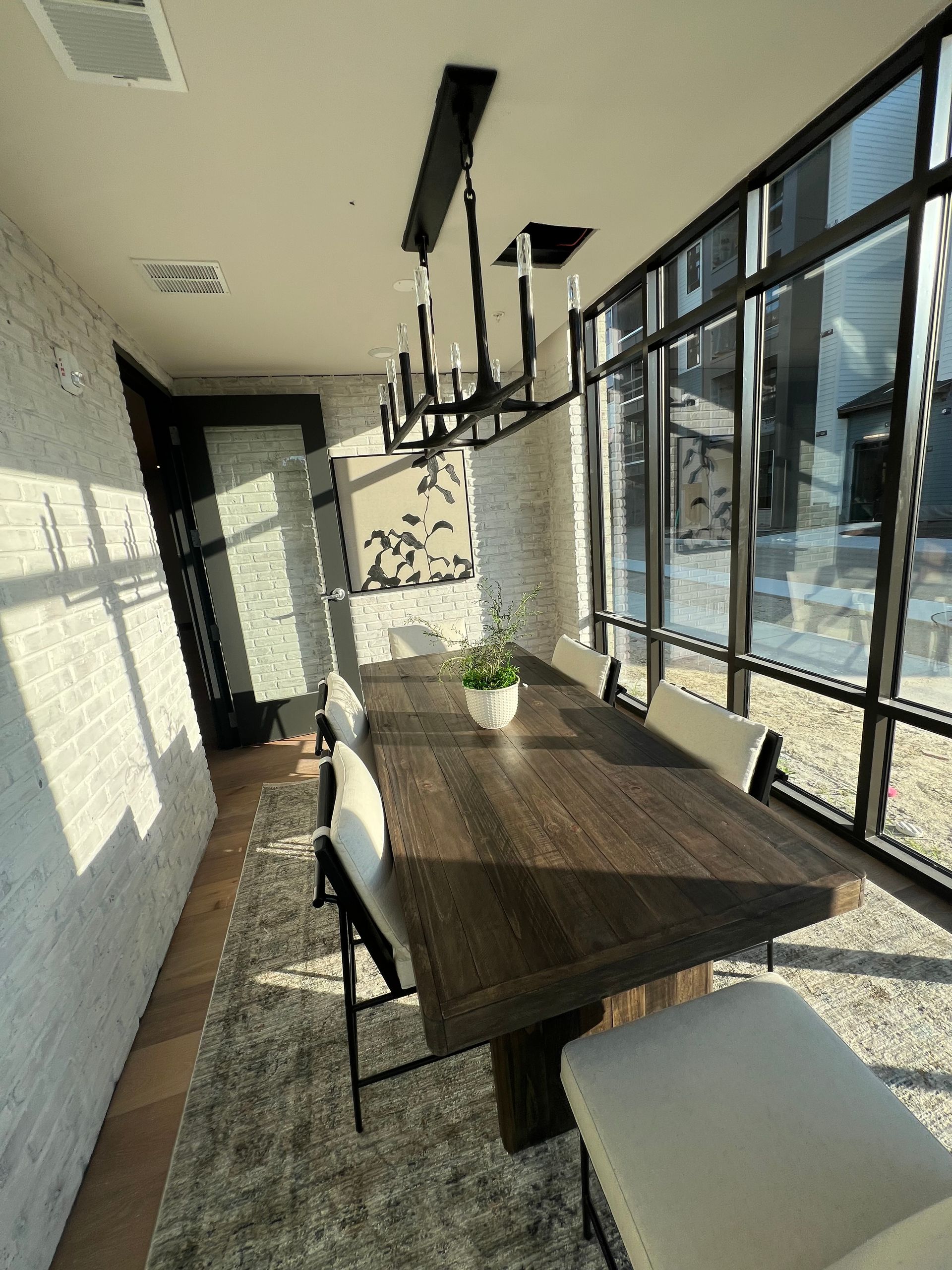 A dining room with a long wooden table and chairs