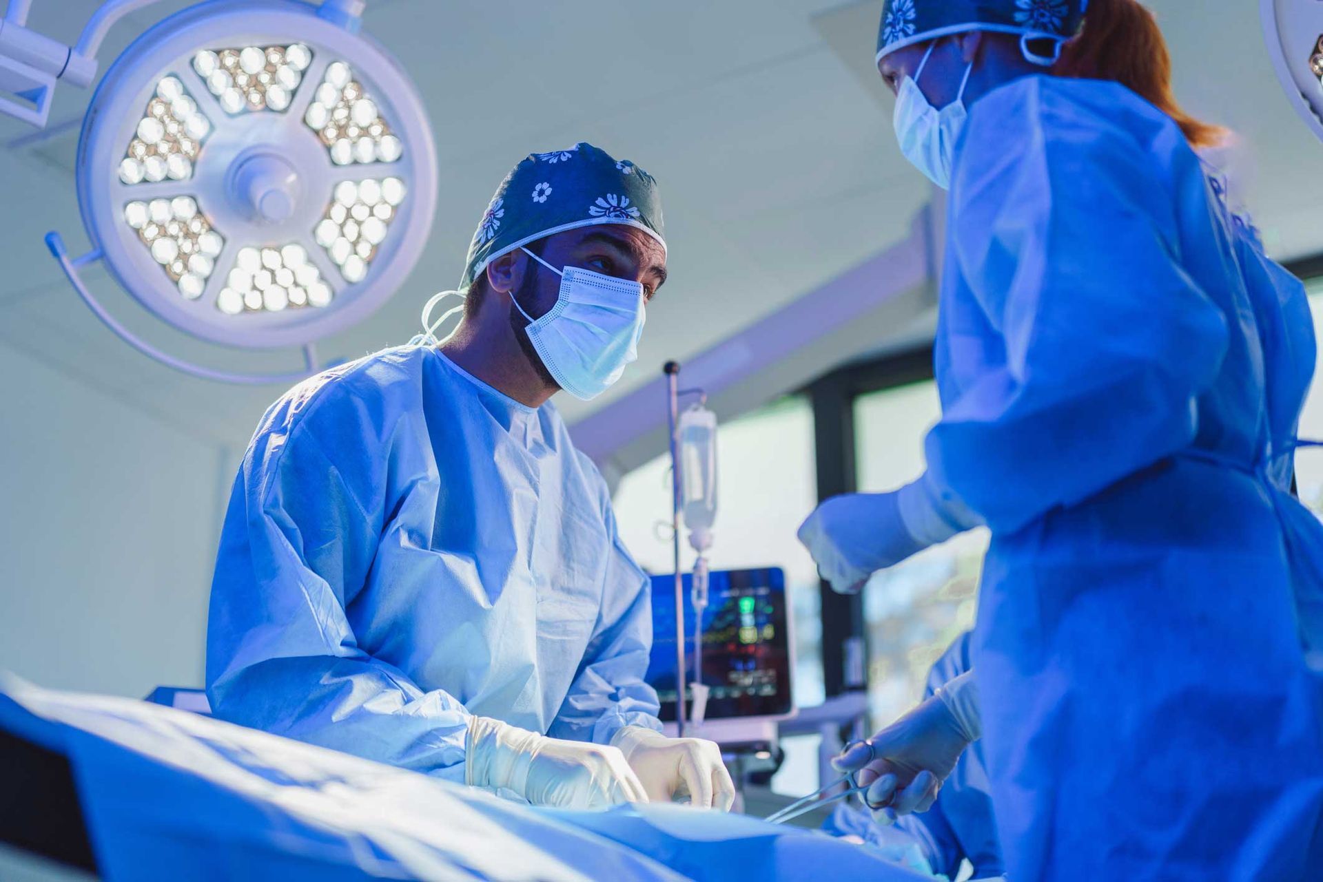 A surgeon is operating on a patient in an operating room.