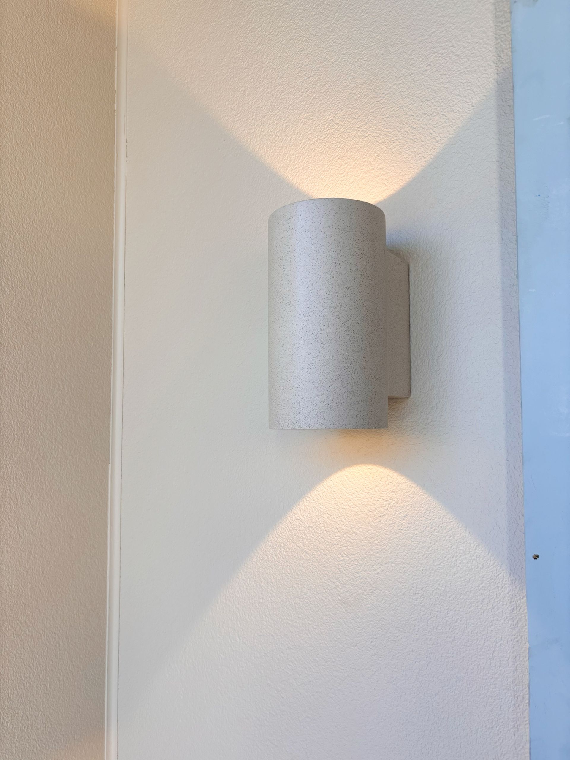  Home Electrical. A white wall light is sitting on a white wall.