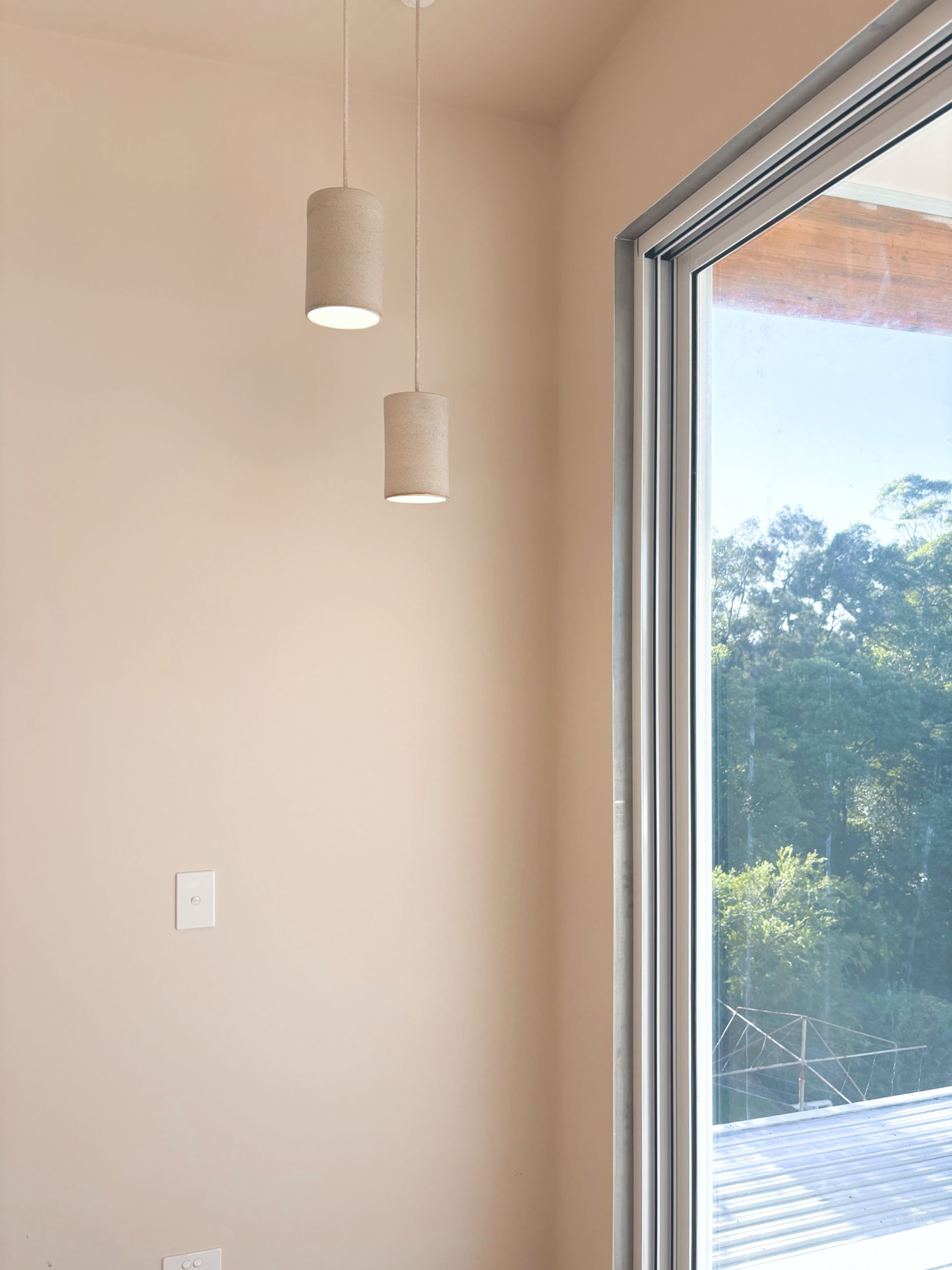  Home Electrical. A room with a sliding glass door and two pendant lights hanging from the ceiling.