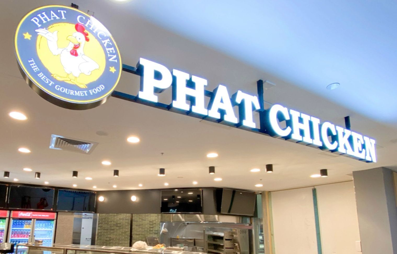 A restaurant called phat chicken is located in a mall with down lighting completed by commercial Electrician 