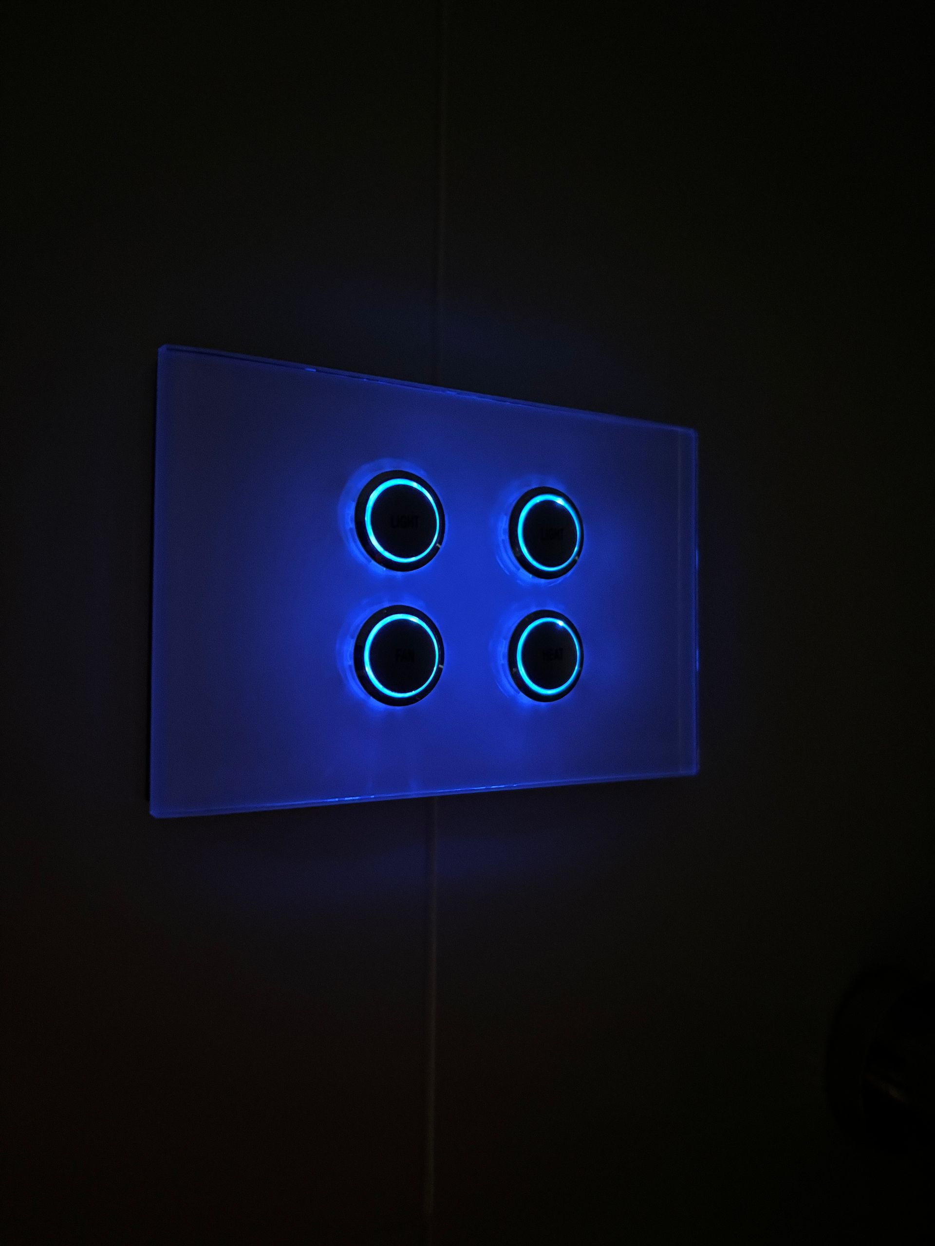  Home Electrical - A blue light switch with four circles on it. 