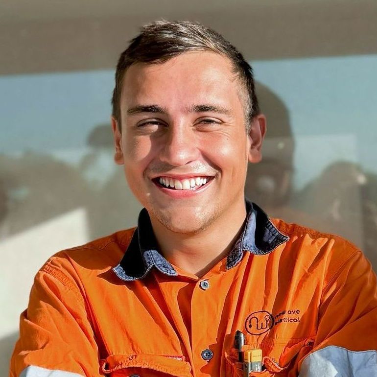 An Electrical Apprentice - man in an orange shirt is smiling for the camera