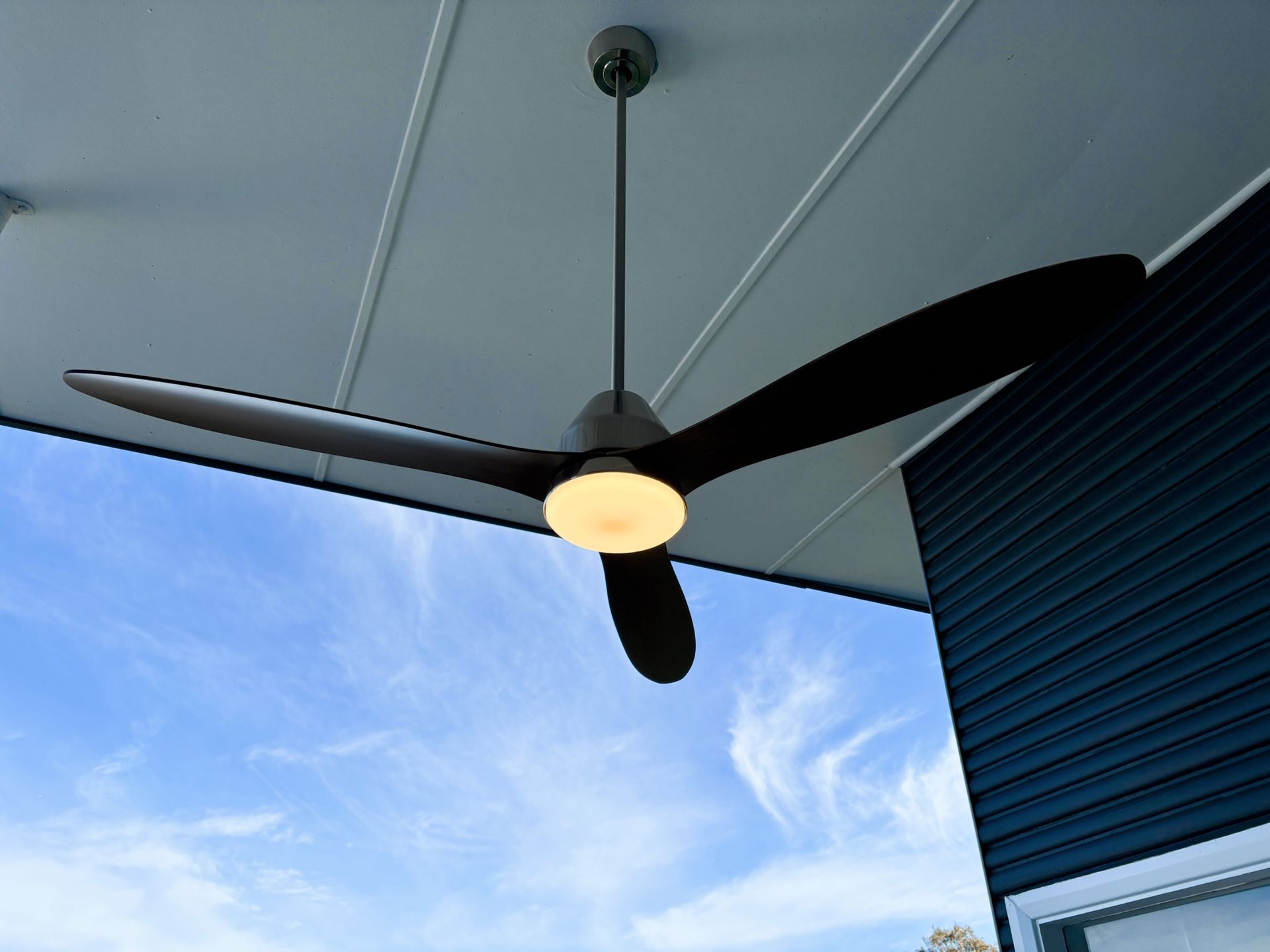 A ceiling fan is hanging from the ceiling of a building