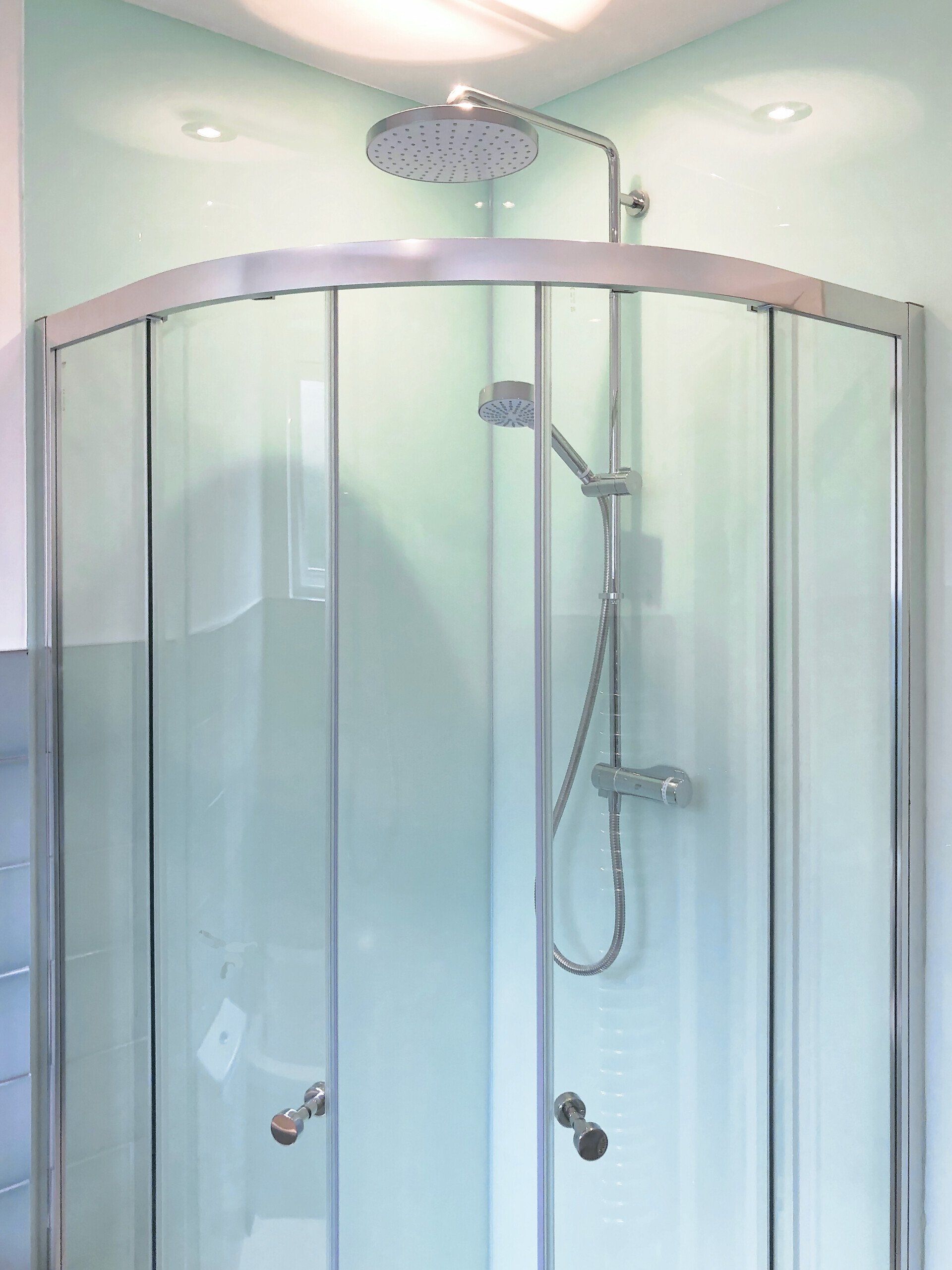 A shower stall with a shower head on top of it.