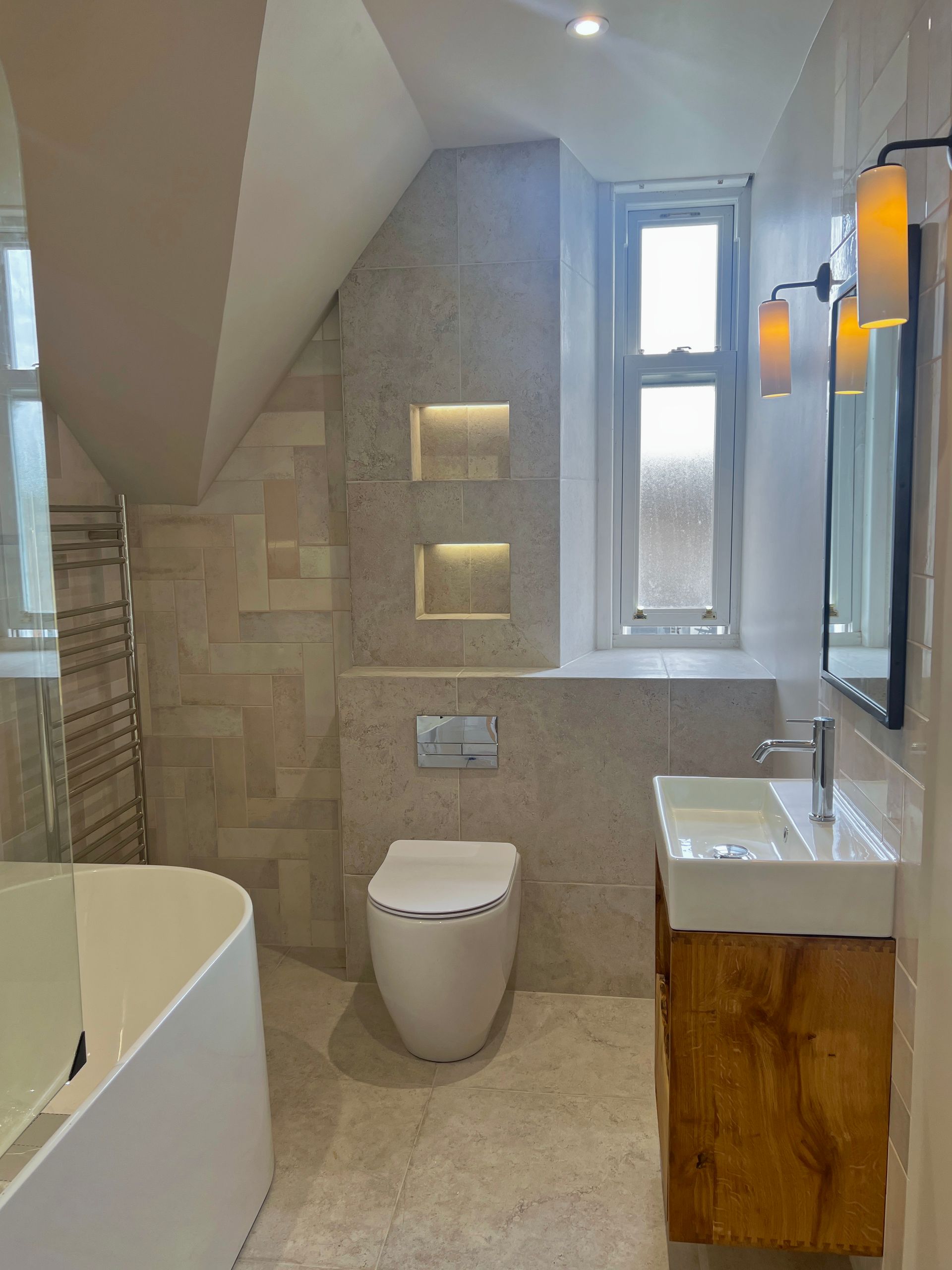 A bathroom with a bathtub , sink , shower and mirror.