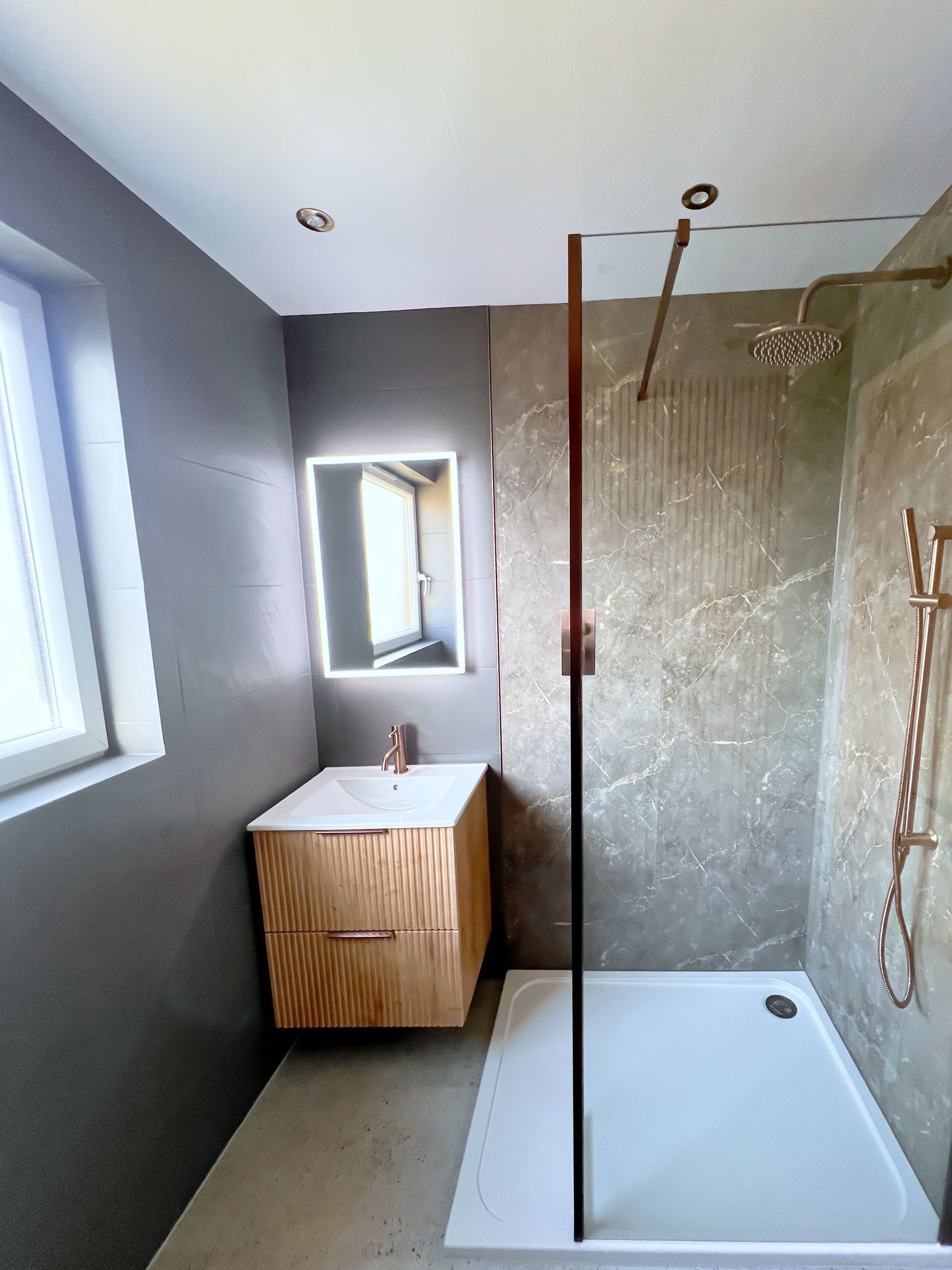 A completely re-designed wet room with sink, toilette and a walk-in shower. 