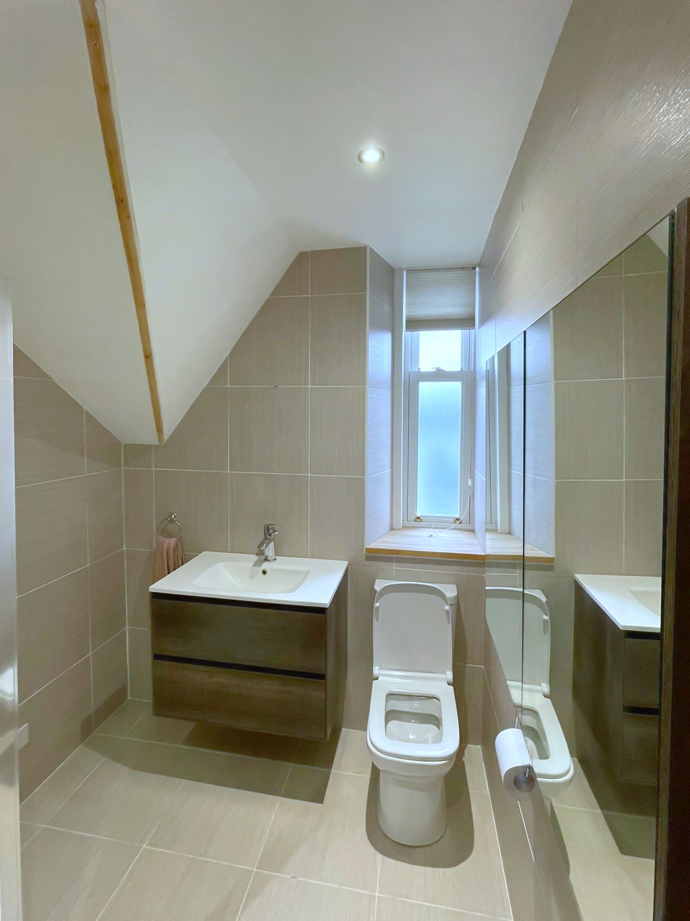 A bathroom with a tub , sink , shower and mirror.