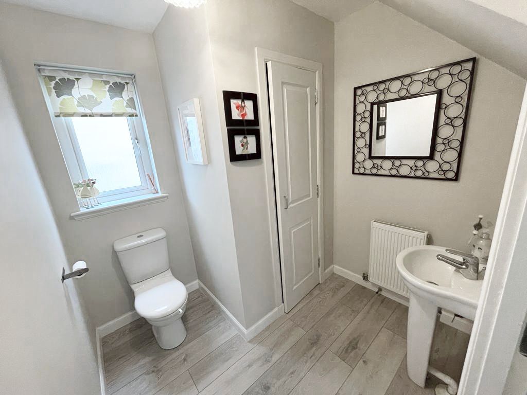 The old bathroom with a toilet, a sink and a mirror.