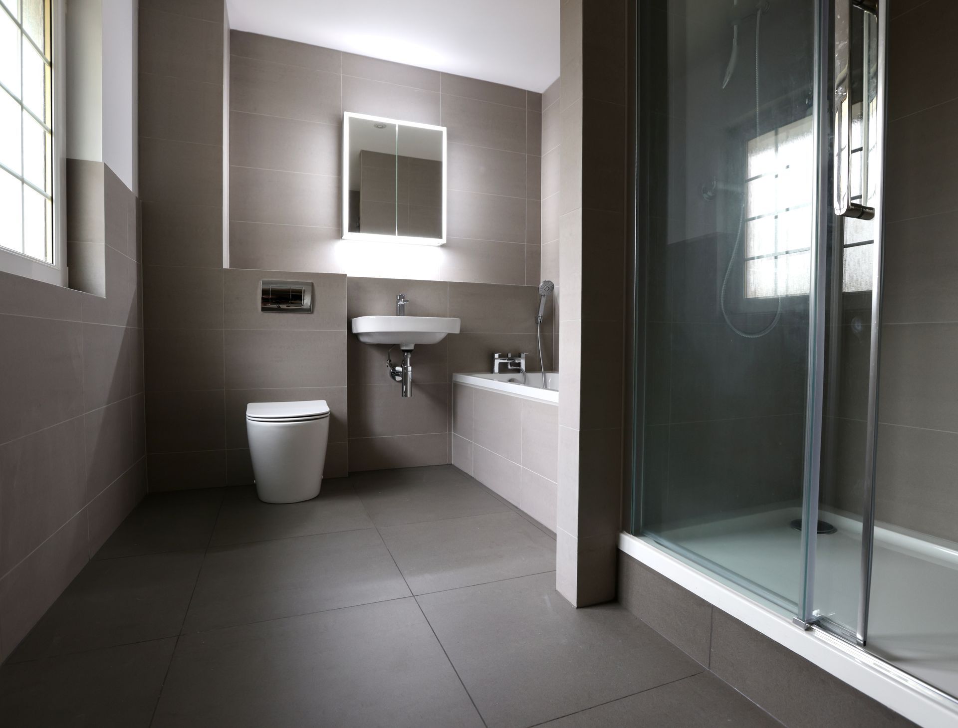 A completely re-designed wet room with sink, toilette and a walk-in shower. 