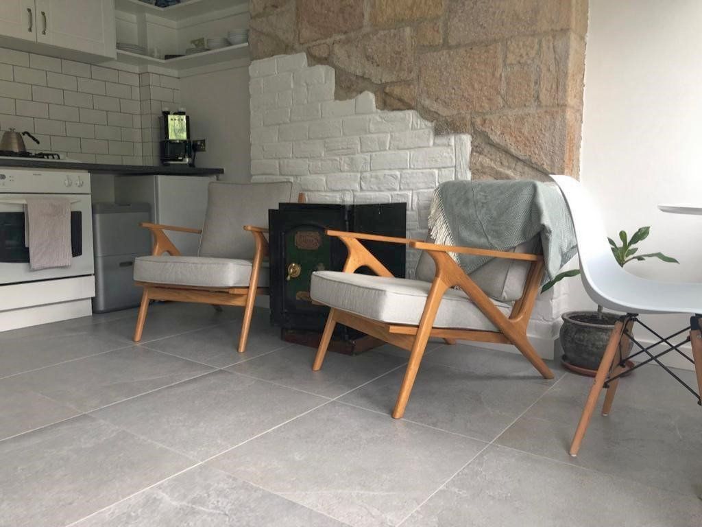 Two chairs are sitting in a living room next to a fireplace.