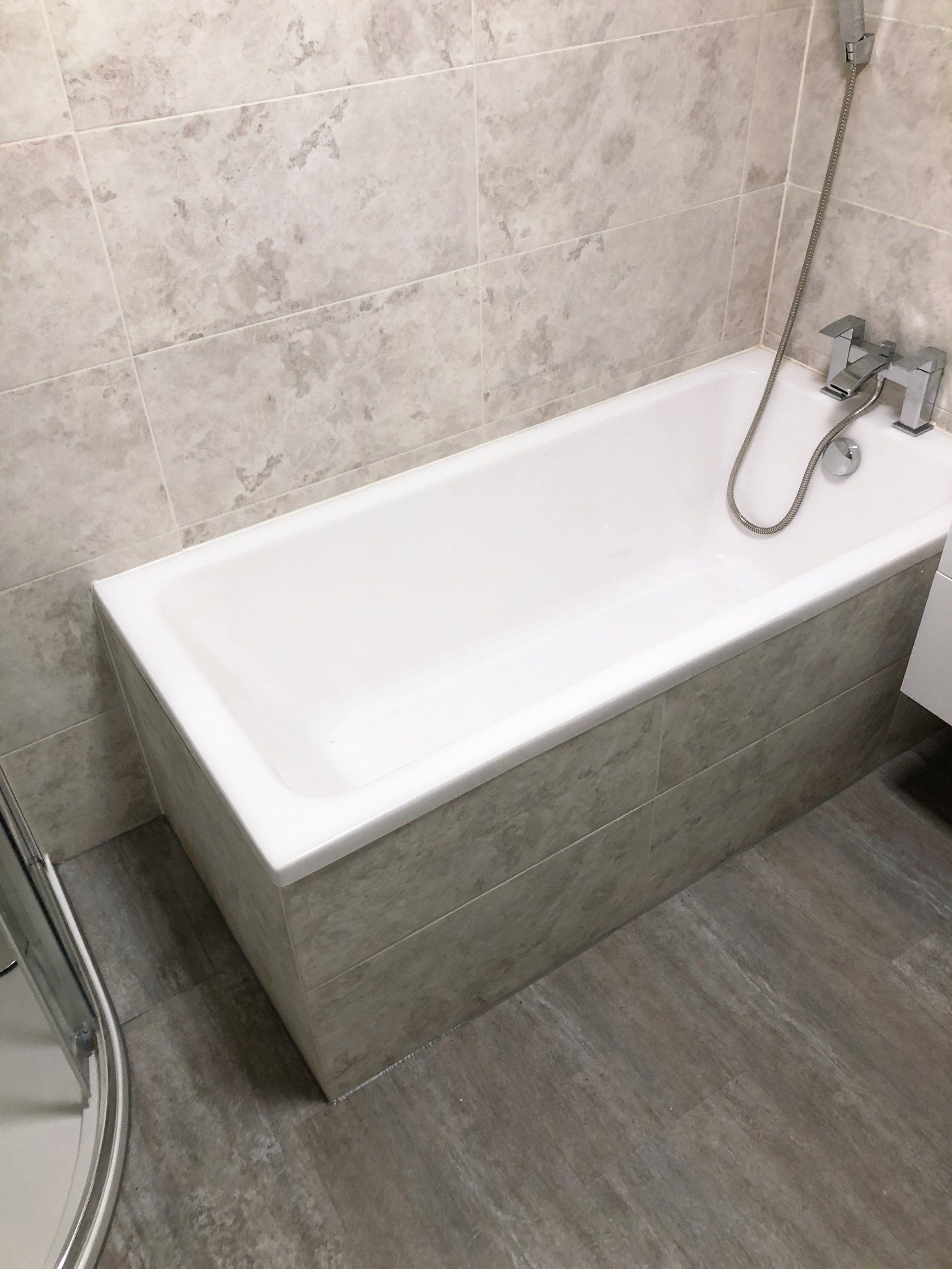 A bathtub with a shower head attached to it in a bathroom.