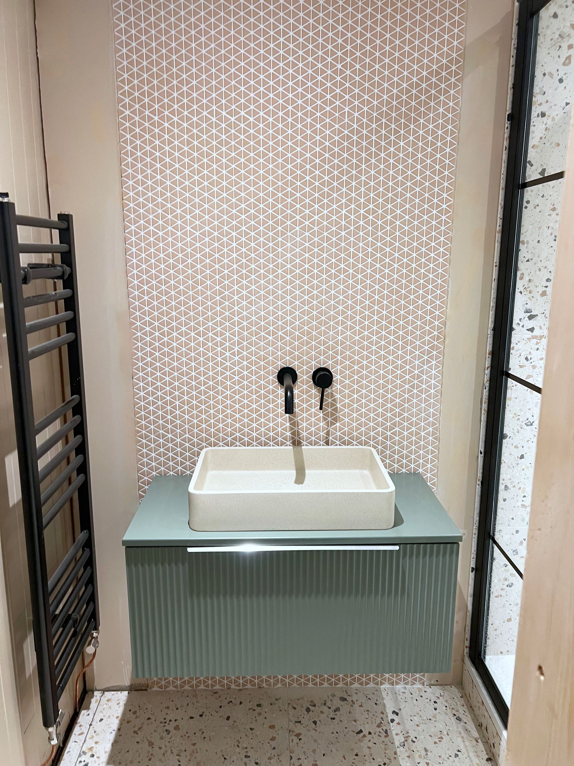 A bathroom with a sink and a towel rack.