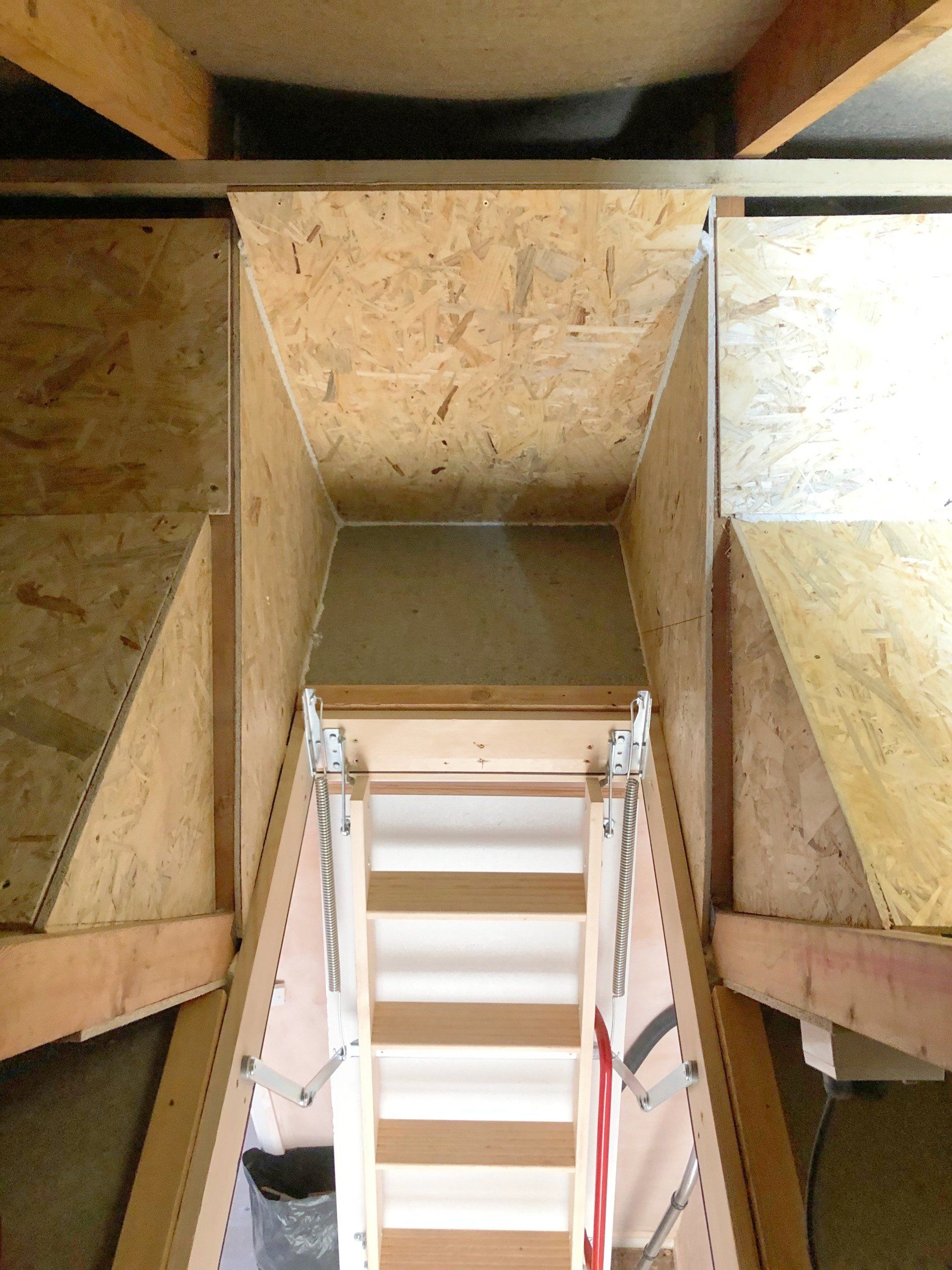 A wooden staircase leading up to the attic.