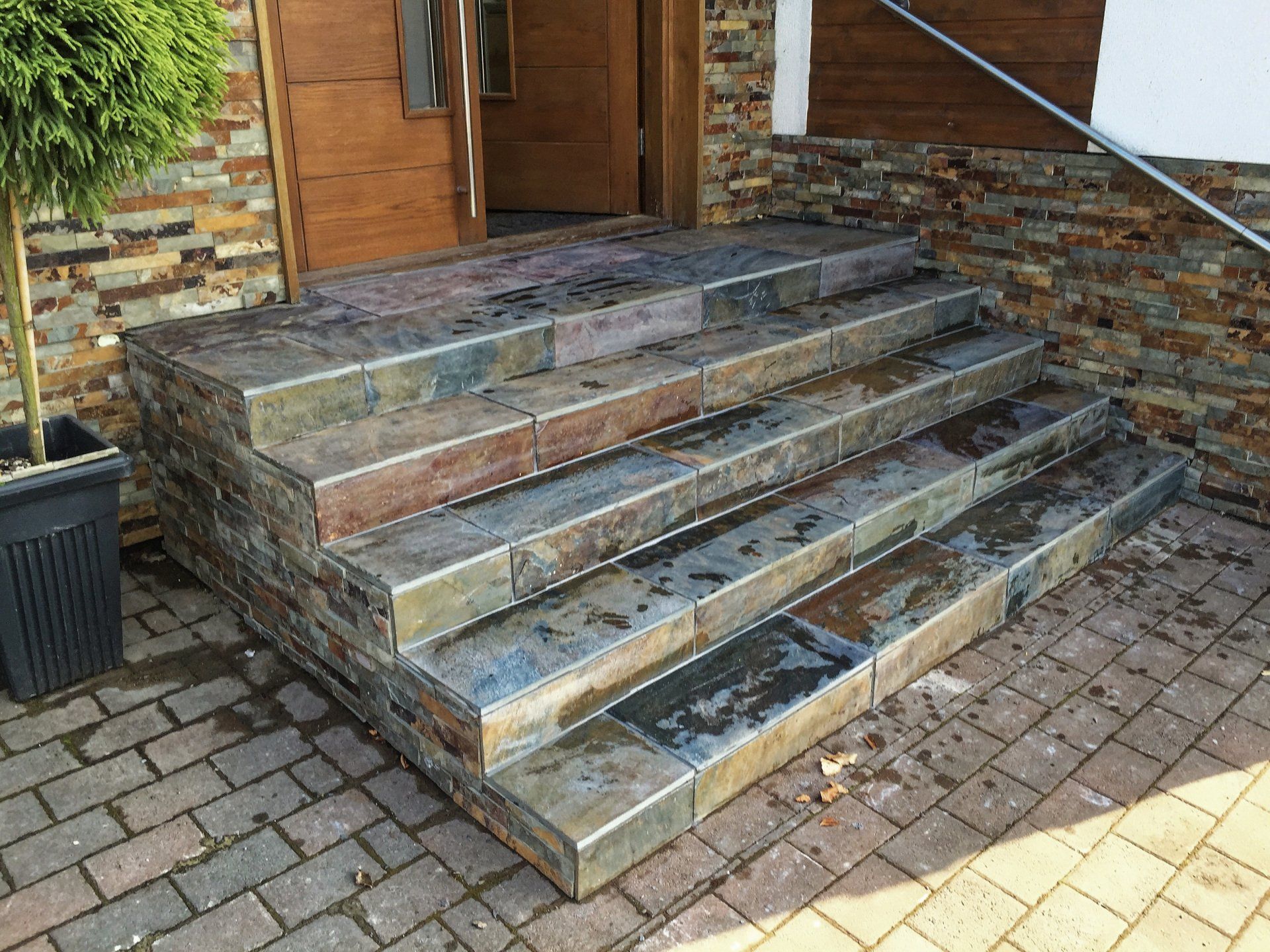 A set of tiled stairs leading up to a house.