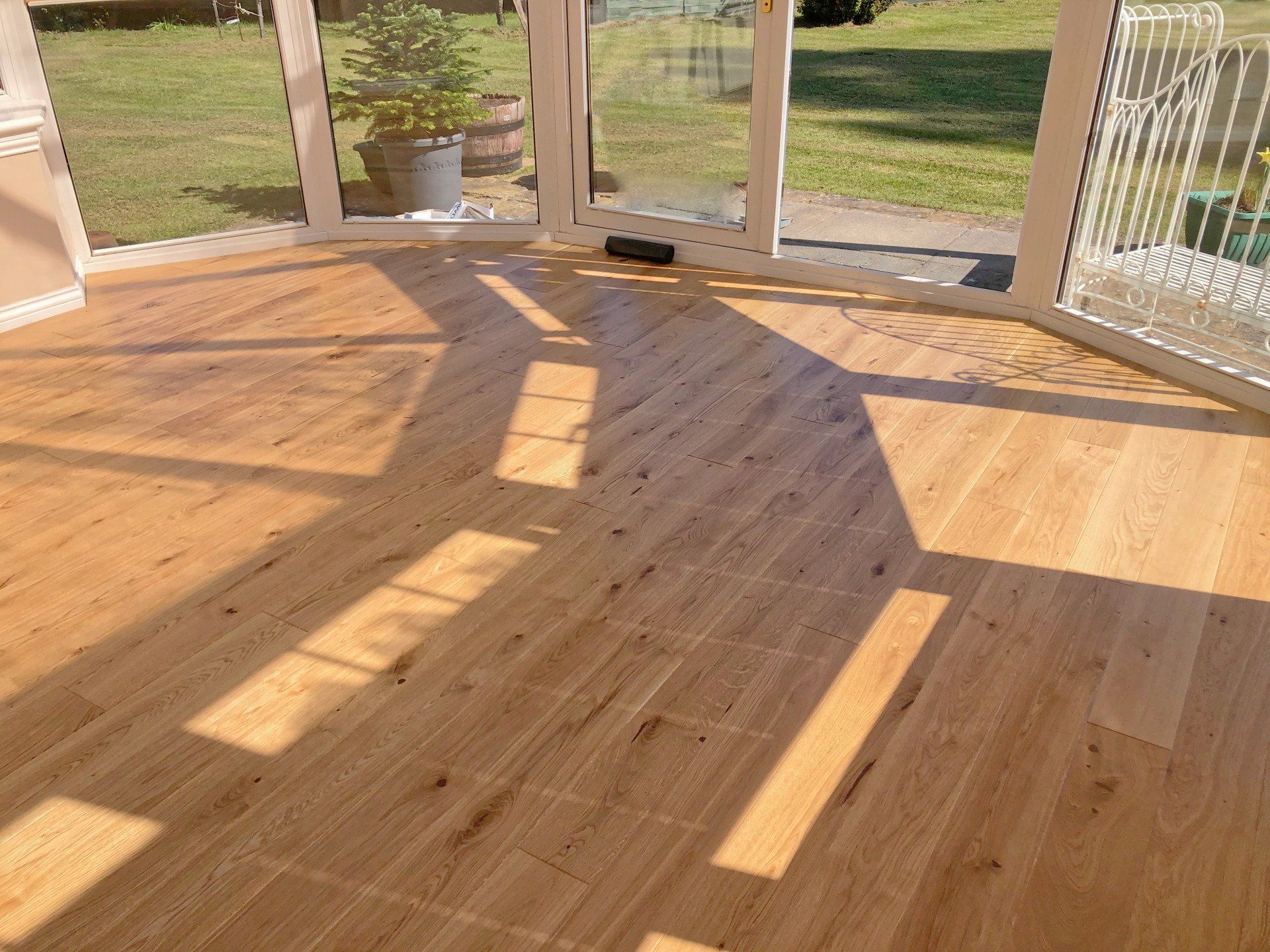 A conservatory with a wooden floor and a sliding glass door