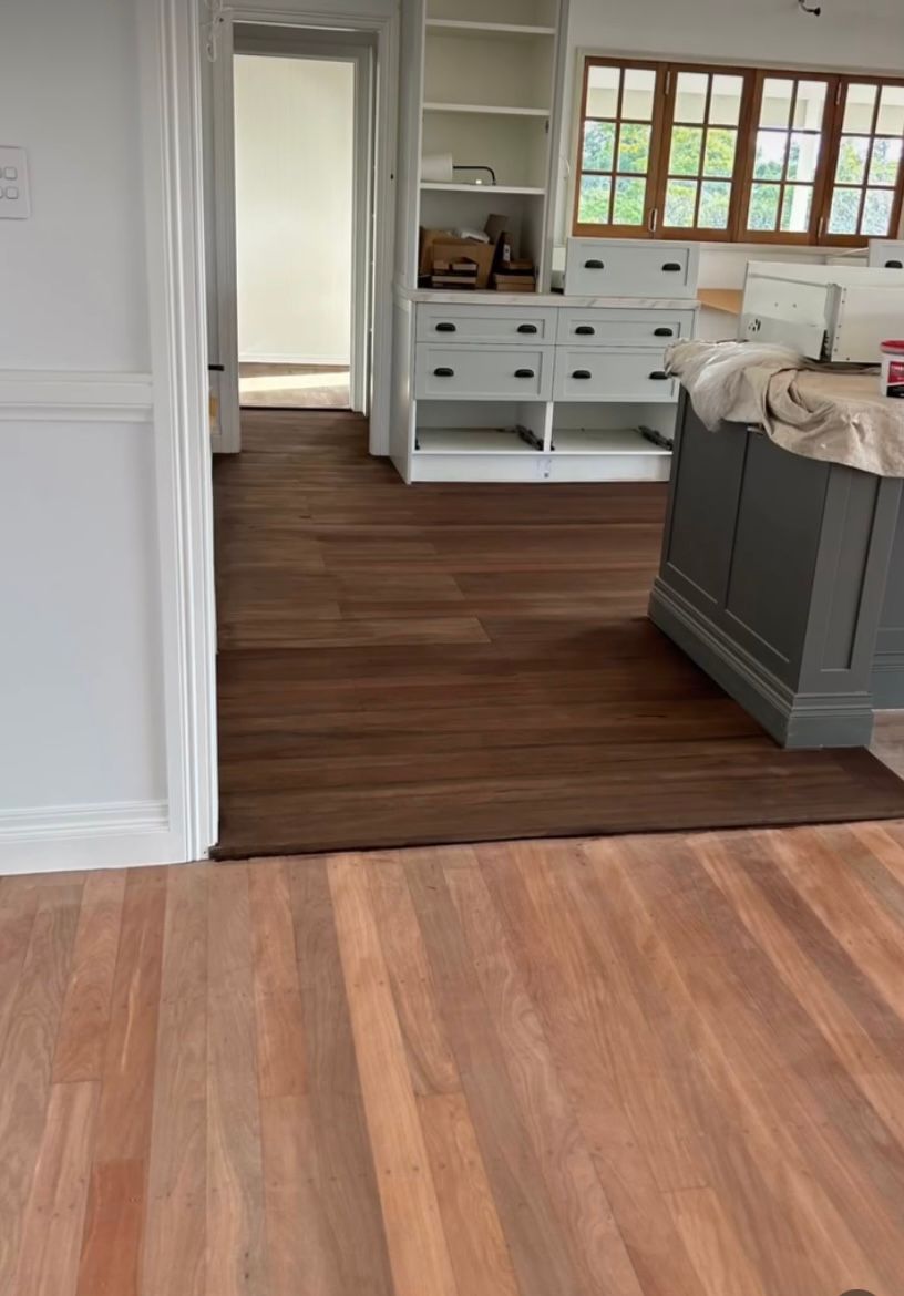 A Walk in Wardrobe With Wooden Floorboards Dark Stained— Byron Floor Sanding In Byron Bay, NSW