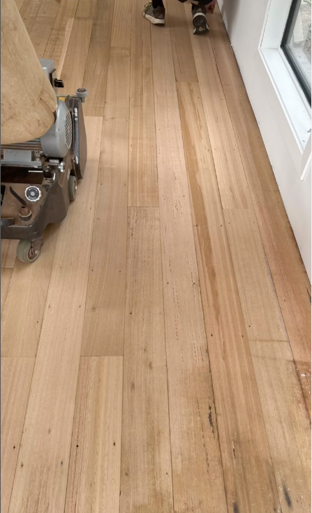 A Wooden Floor being Sanded With A Machine — Byron Floor Sanding In Byron Bay, NSW