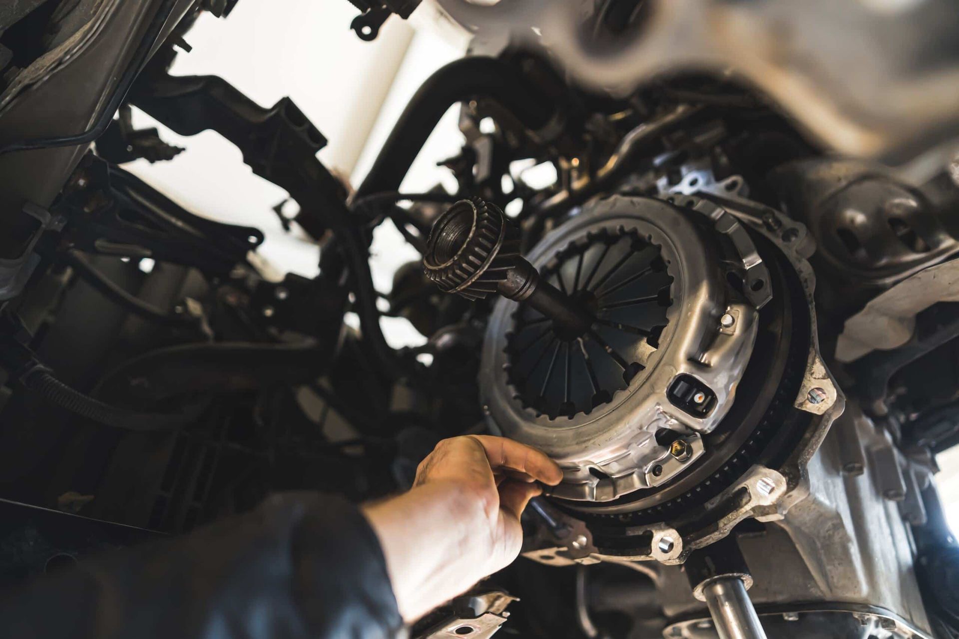 A Person is Working on a Car Clutch With a Wrench — Steve's Service Centre in Albury, NSW 