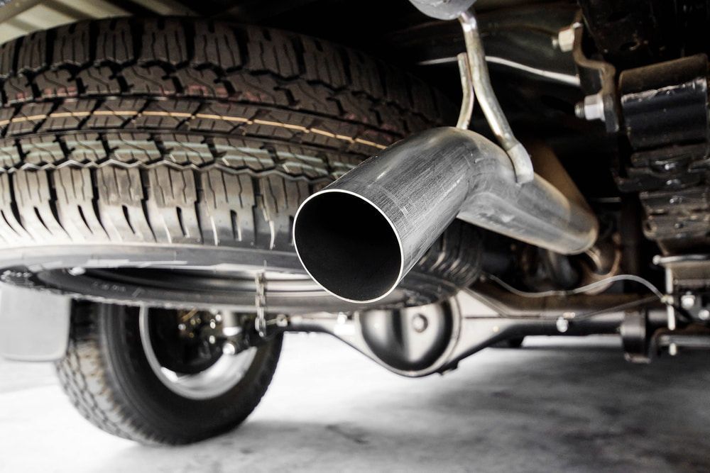 A Close Up of the Underside of a Car With a Tire and Exhaust Pipe — Steve's Service Centre in Albury, NSW 