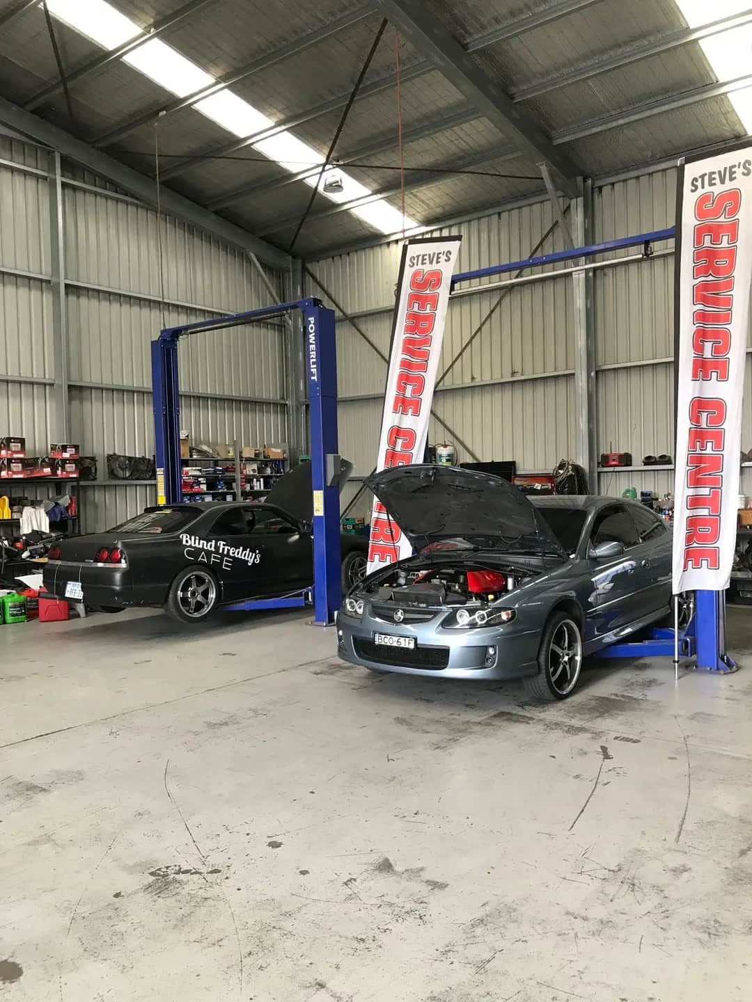 Two Cars Are Parked in a Garage With Their Hoods Open — Steve's Service Centre in Albury, NSW