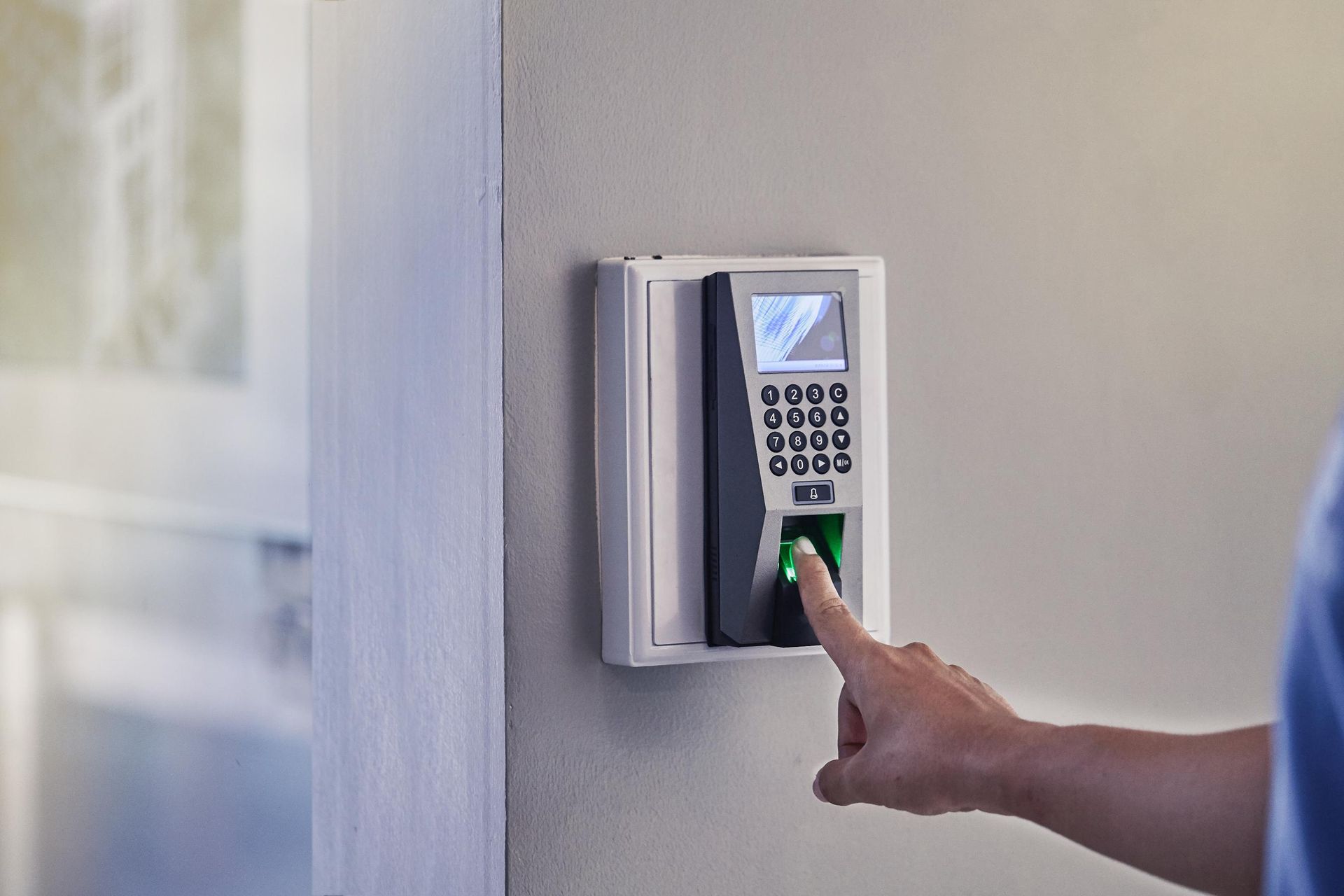 Finger scanning device being used to unlock access to a building.
