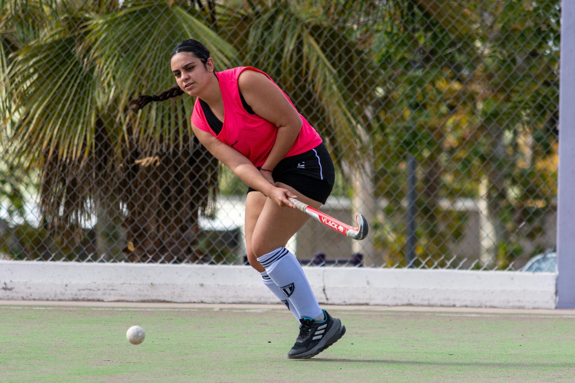 A woman is playing field hockey on a field.