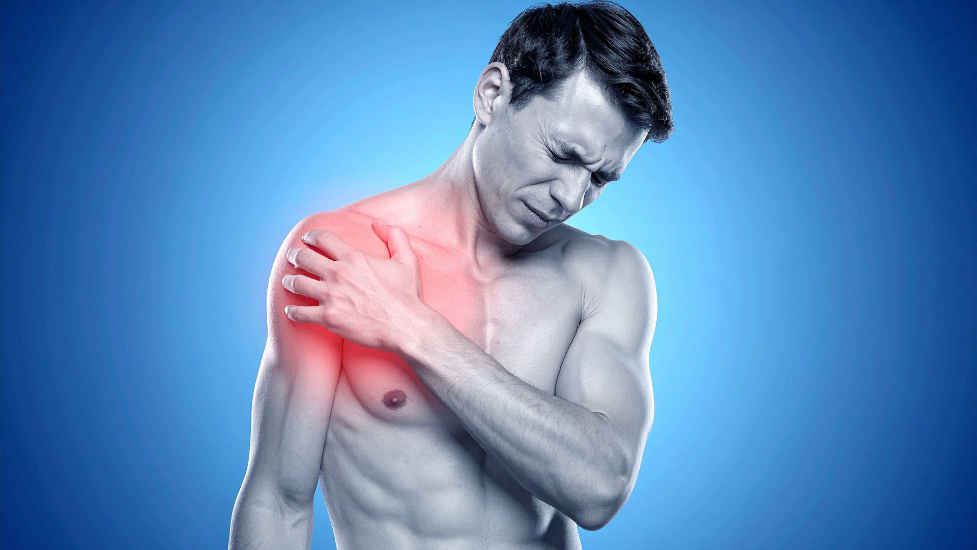 Man clutching shoulder, red highlight indicating pain, blue background.