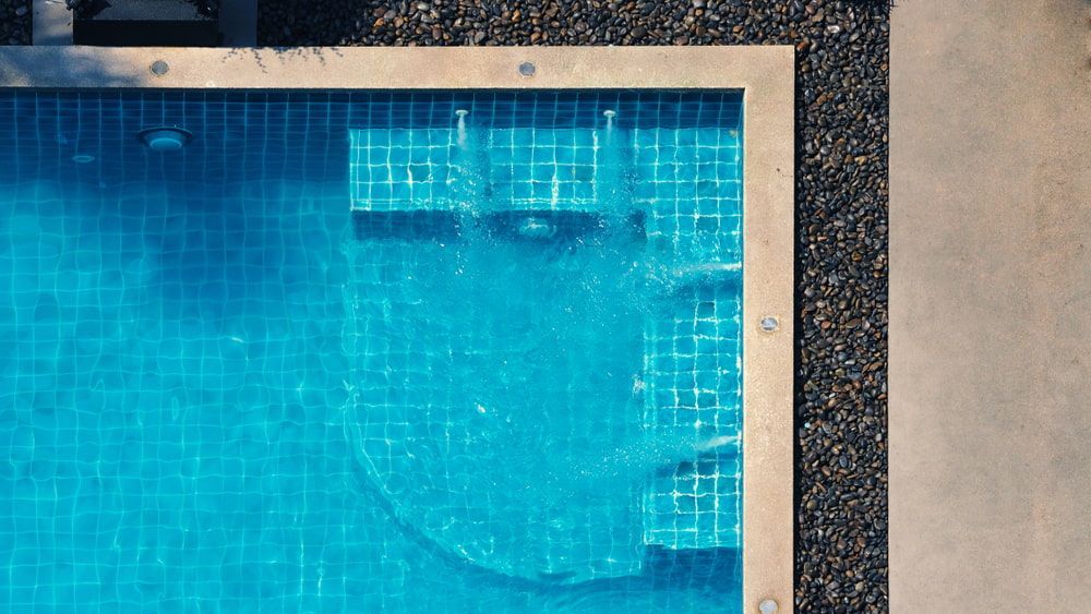 An Aerial View of A Swimming Pool with Blue Tiles — Gary Arnold Water Supplies in Uki, NSW