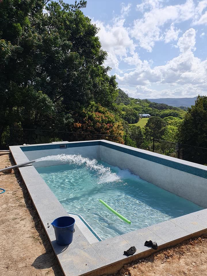 A Large Swimming Pool Is Being Built On Top Of A Dirt Hill — Gary Arnold Water Supplies in Uki, NSW