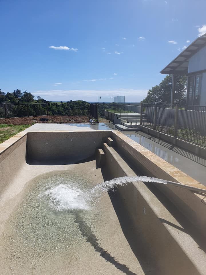 A Swimming Pool With A Fountain In The Middle Of It — Gary Arnold Water Supplies in Uki, NSW