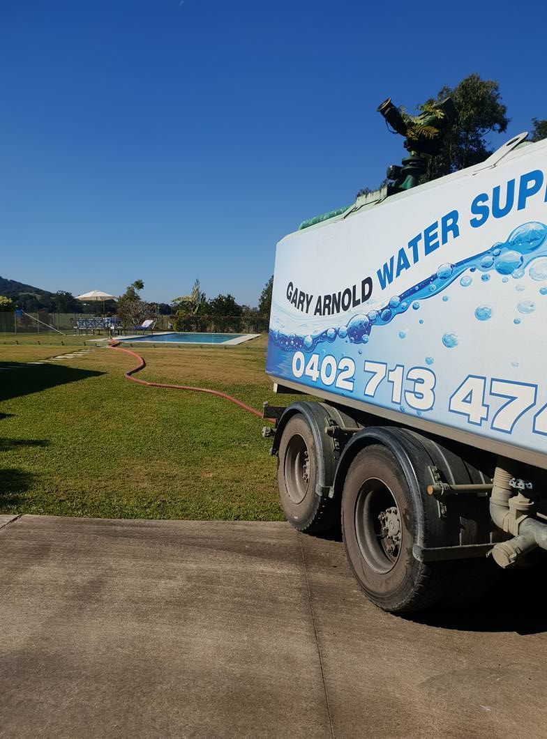 A Water Supply Truck Is Parked On The Side Of The Road — Gary Arnold Water Supplies in Byron Bay, NSW