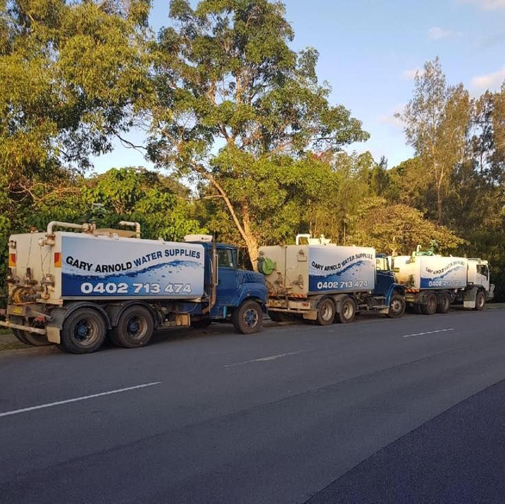 3 Water trucks lined up on a road  — Gary Arnold Water Supplies in Uki, NSW