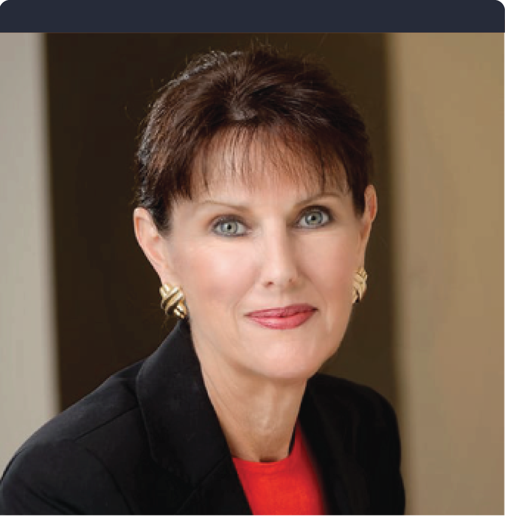 A woman wearing a red shirt and a black jacket looks at the camera