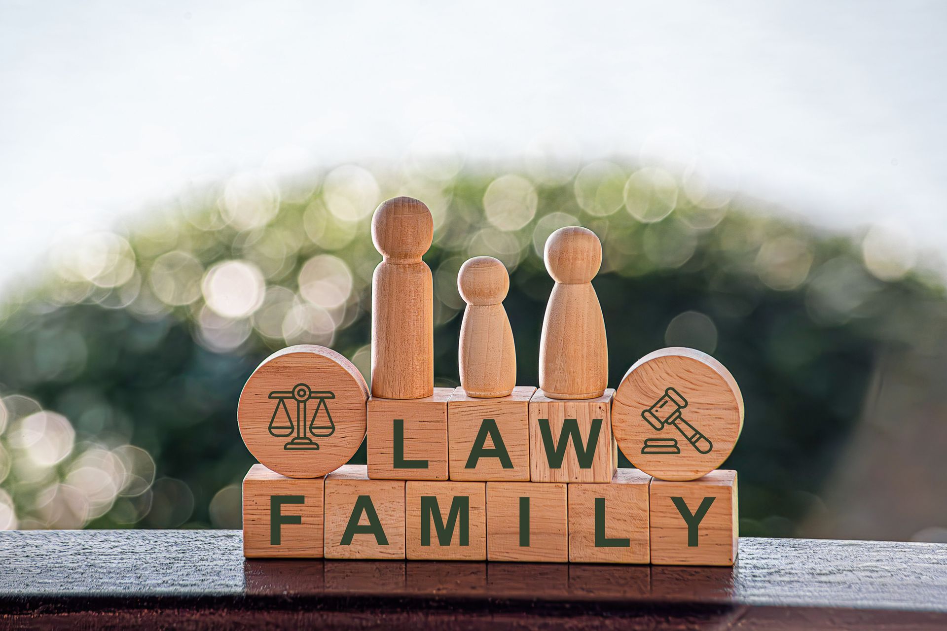 A judge 's gavel is sitting on a wooden table in front of a stack of books.