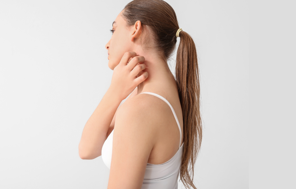 A woman is scratching her neck with her hand.