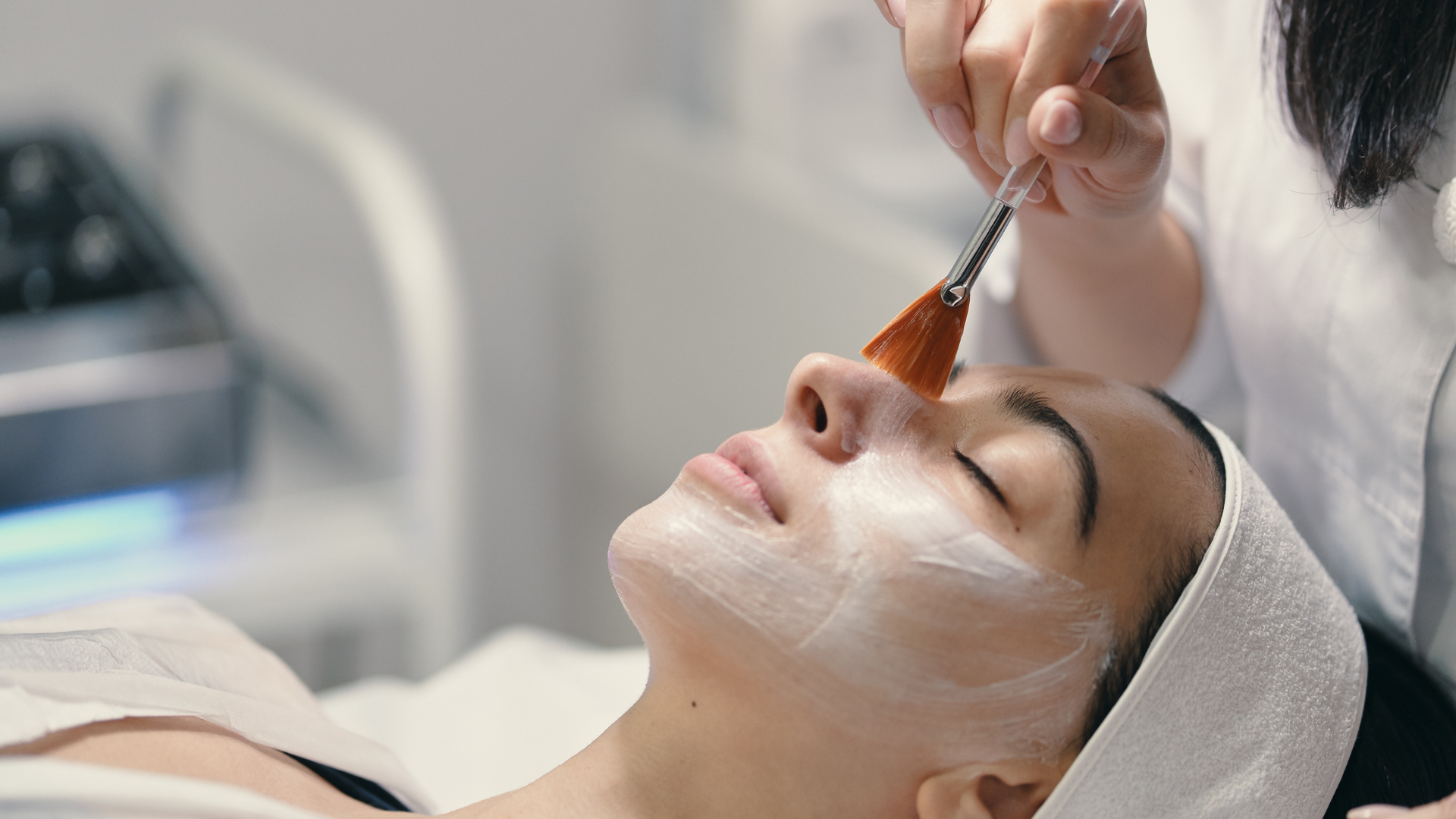 A close up of a woman 's brown eye with a spot on her forehead.