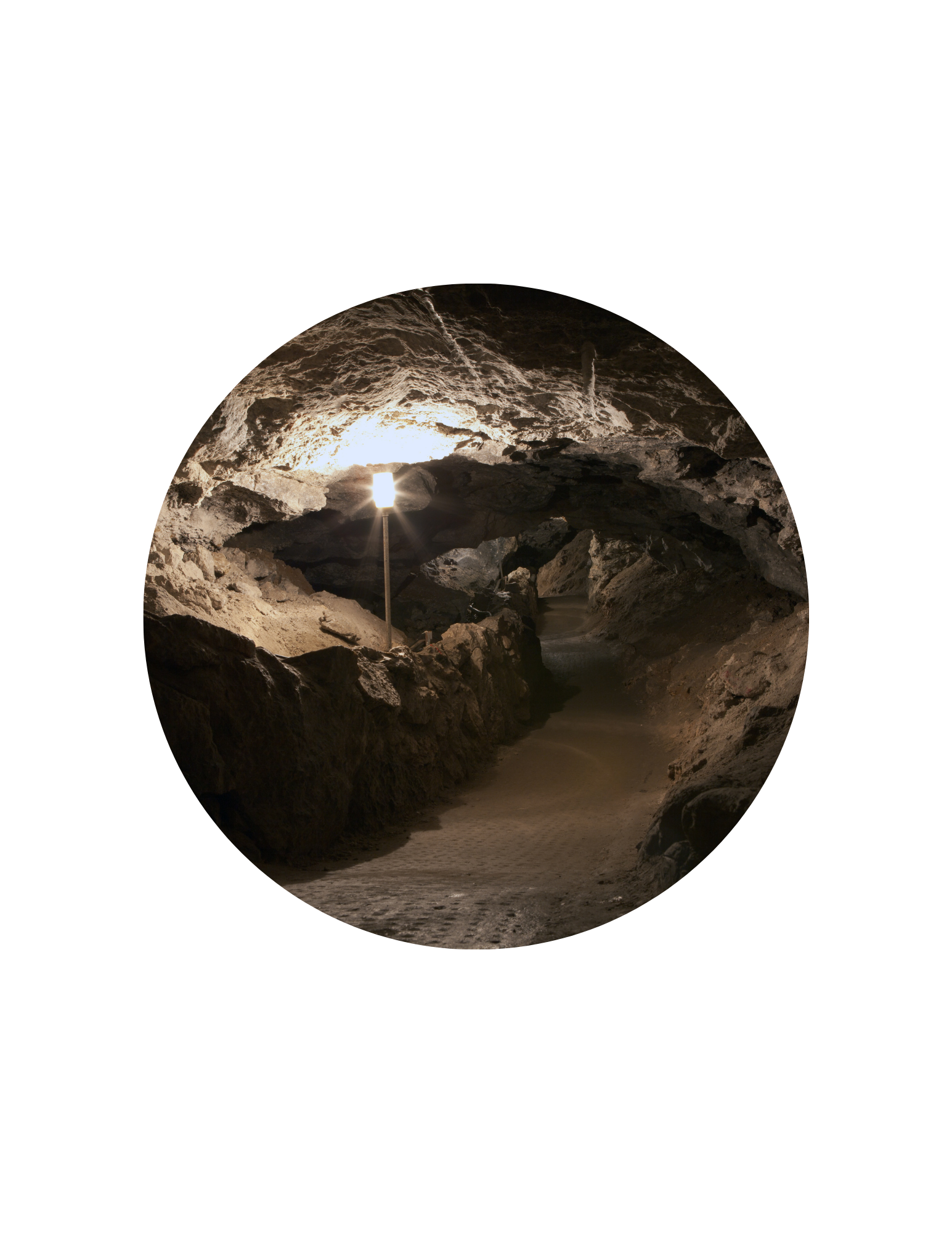 tunnel lined with rocks and light hanging from ceiling