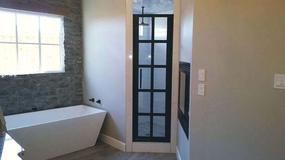 A bathroom with a bathtub and a walk in shower.