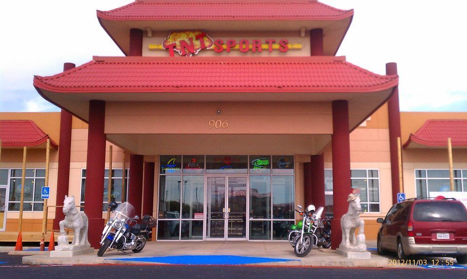 Motorcycles are parked in front of a building that has the word express on it